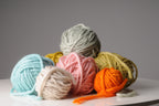 Colorful yarn balls on a gray background